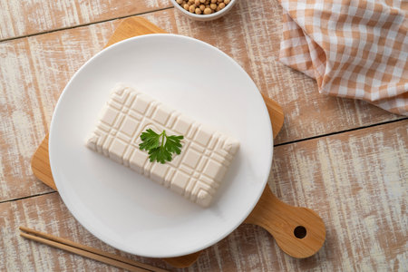 Fresh White Tofu soy bean curd on white plate.Top view