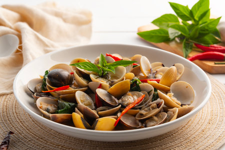 Stir Fried Clams with Sweet Basil in a plate.Thai food.(Puff meretrix or Meretrix casta)の写真素材