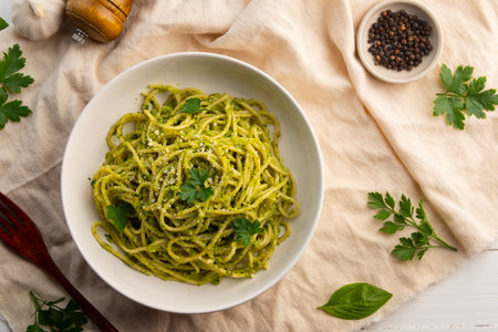 Vegetarian vegan green pasta, Spaghetti pasta with broccoli pesto sauce and vegan cheese in white plate.Healthy food.Top view.の写真素材