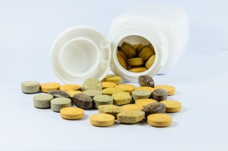Prescription pill bottle spilling pills on to surfaceの写真素材