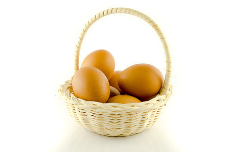 Eggs in basket on white backgroundの写真素材