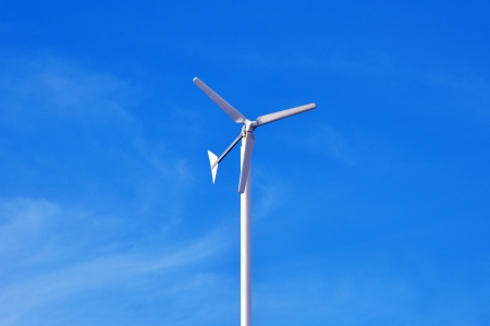 Wind turbine againt blue sky backgroundの写真素材