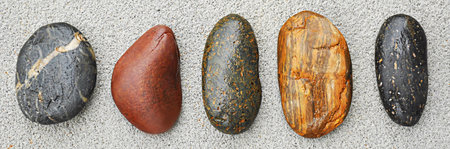 Five stones on concrete groundの写真素材