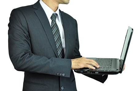 Businessman holding and typing laptop computerの写真素材