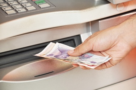 Man taking money from ATMの写真素材