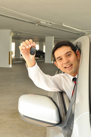 Businessman giving a car keyの写真素材