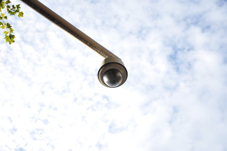 Round shape CCTV on cloudy sky background