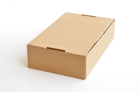 Brown cardboard box as a parcel - isolated on whiteの写真素材