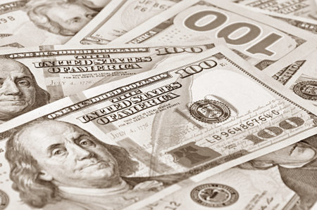 Money - 100 United States dollars (USD) bills - focusing on words THE UNITED STATES OF AMERICA