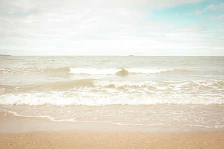 Lapping wave on the beach - retro color effectの写真素材