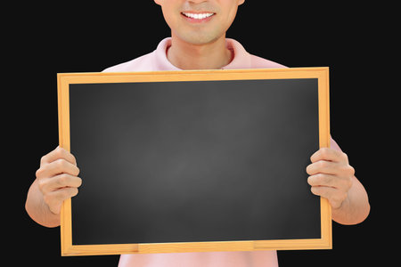 Smiling man holding empty blackboard - can fill your texts & used as placard, notice & advertising boards etc.の写真素材