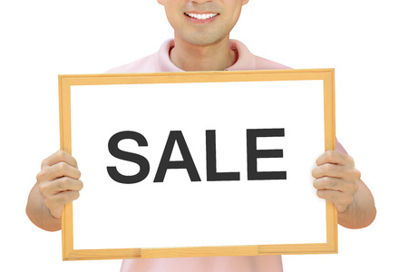 SALE sign on whiteboard held by smiling manの写真素材