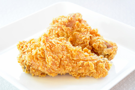 Fried chicken legs on a white plateの写真素材