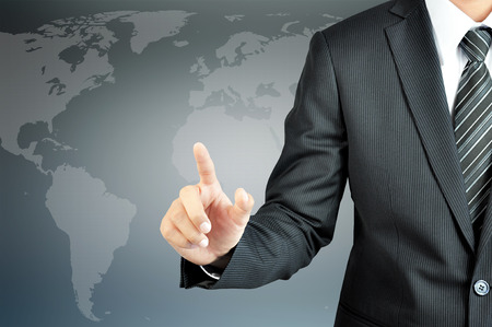 Businessman hand pointing with world map background  - can put your texts or pictures at the fingerの写真素材
