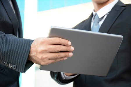 Two businessmen looking at tablet pc - business discussion conceptの写真素材