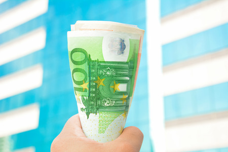 Money in the fist - Euro  currency (EUR)の写真素材