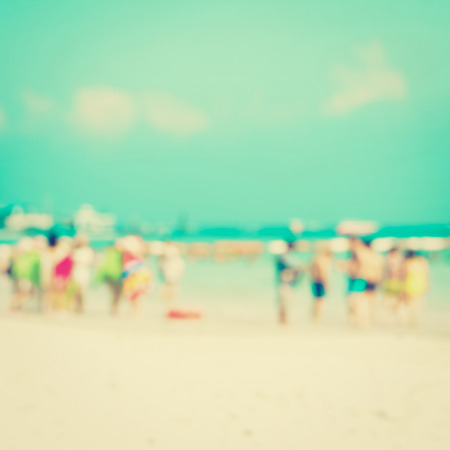 Blurred people on white sand beach - vintage toneの写真素材