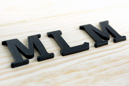 MLM (or Multi-Level Marketing) sing on wood backgroundの写真素材