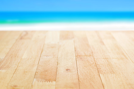 Wood table top on blurred beach background- can be used for display or montage your productsの写真素材