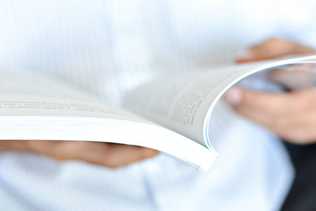 Blurred image of a man hands opening book