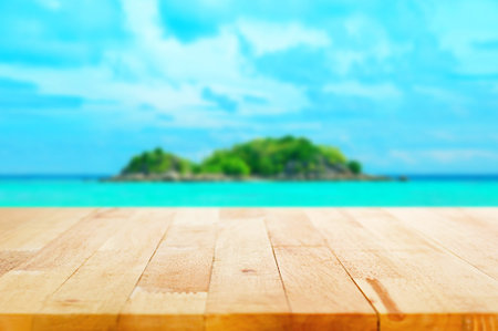 Wood table top on blur  island background - can be used for montage or display your products