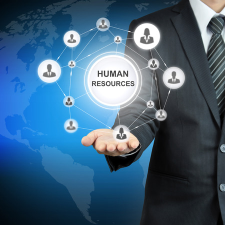 HUMAN RESOURCES sign with people icon network on businessman hand HUMAN RESOURCES sign with people icon network on businessman hand