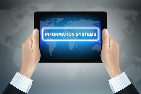 INFORMATION SYSTEM sign on tablet pc screen held by businessman handsの写真素材