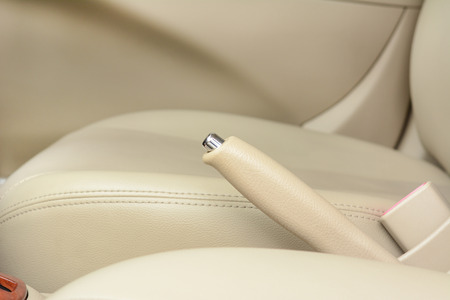 Car hand brake lever near driver seat - beige colorの写真素材