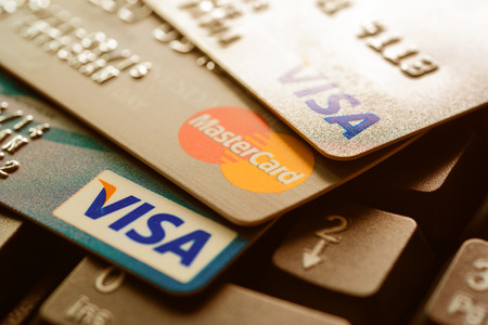Bangkok, Thailand - Jun 23, 2015 : Group of credit cards on computer keyboard with VISA and MasterCard brand logosのeditorial素材