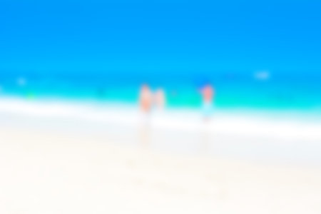 Blurred image of white sand beach and blue sea for backgroundの写真素材