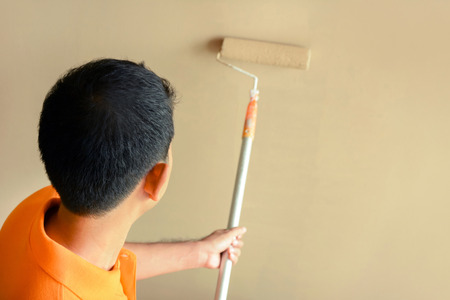 Painter painting wall with rollerの写真素材