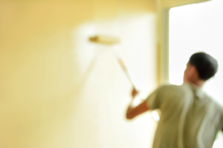 Blurred image of painter paiting wall with rollerの写真素材