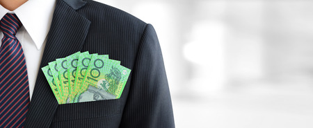Money,Australian dollar (AUD) banknotes, in businessman suit pocket - financial and investment panoramic background with copy spaceの写真素材