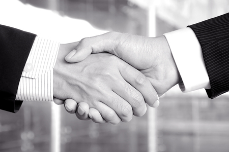 Handshake of businessmen in monochrome - congratulation, greeting & business partner conceptsの写真素材