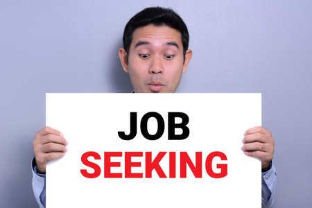 Excited man holding white paper with JOB SEEKING message