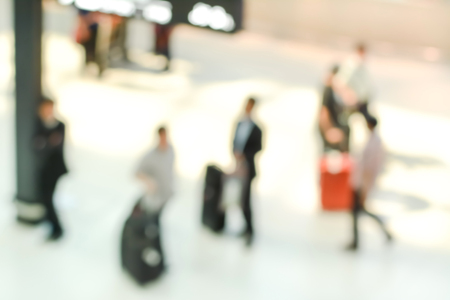 Blur image of people walking inside airport terminalの写真素材