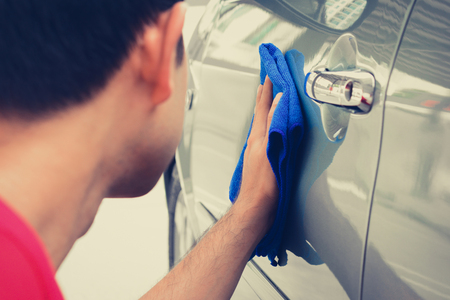 A man cleaning car with microfiber clothの写真素材