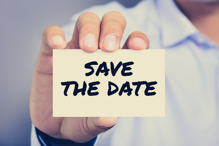 SAVE THE DATE message on the card shown by a man, vintage tone SAVE THE DATE message on the card shown by a man, vintage tone