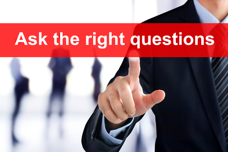 Businessman hand touching ASK THE RIGHT QUESTIONS tab on virtual screenの写真素材
