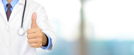 Doctor hand giving thumbs up, panoramic medical header backgroundの写真素材