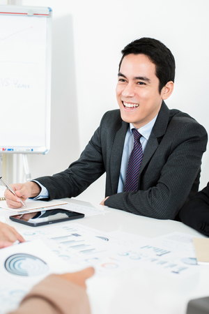 Smiling Asian businessman at the meetingの写真素材