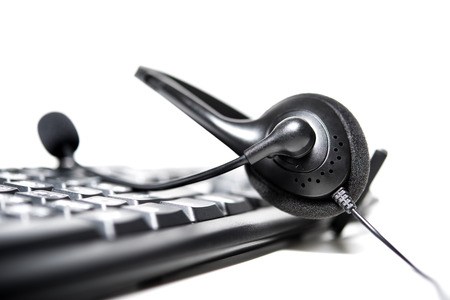 Headset with microphone on computer keyboard - call center conceptの写真素材