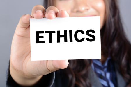 ETHICS, word on the card shown by a businesswomanの写真素材
