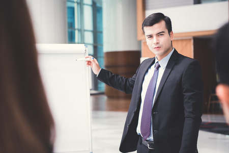 Young businessman as a meeting leader presenting his workの写真素材