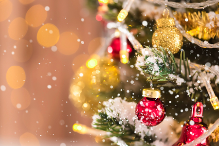 Shiny glittering decorative balls and ornaments on Christmas treeの写真素材