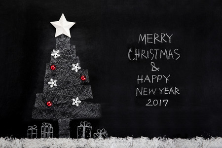 Merry Christmas and Happy New Year 2017 text with decorated Christmas tree on blackboardの写真素材