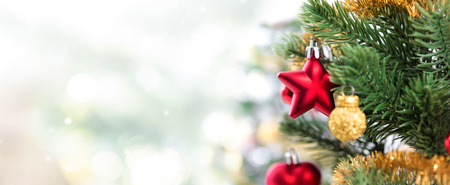 Close up of colorful ornaments on Christmas tree, panoramic banner background with copy spaceの写真素材