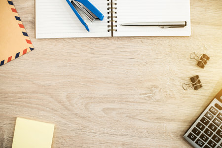 Wood working table with office supplies - top view for backgroundの写真素材