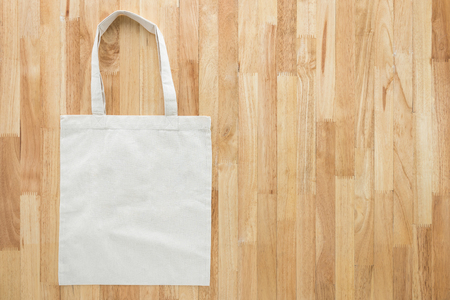 Reusable white fabric shopping bag on wood background with copy spaceの写真素材