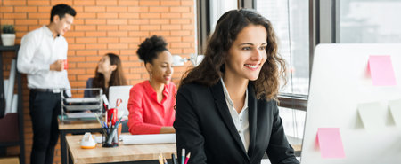 Businesswoman working in creative office with multiethnic colleagues, panoramic banner